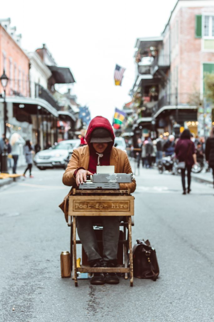 Picture of a person in the middle of the road with a typewriter