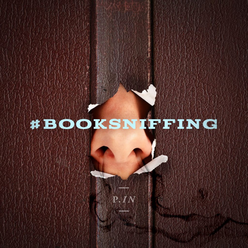 a picture of a nose poking through a book with the hashtag booksniffing