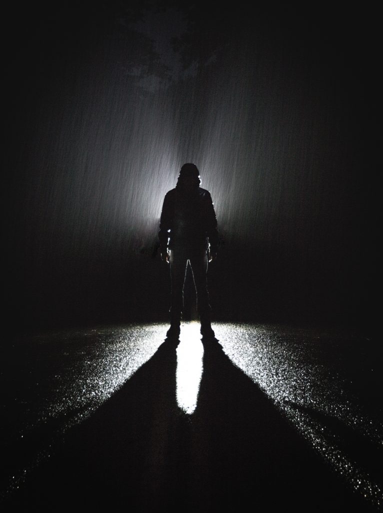 A picture of a man stood in rain