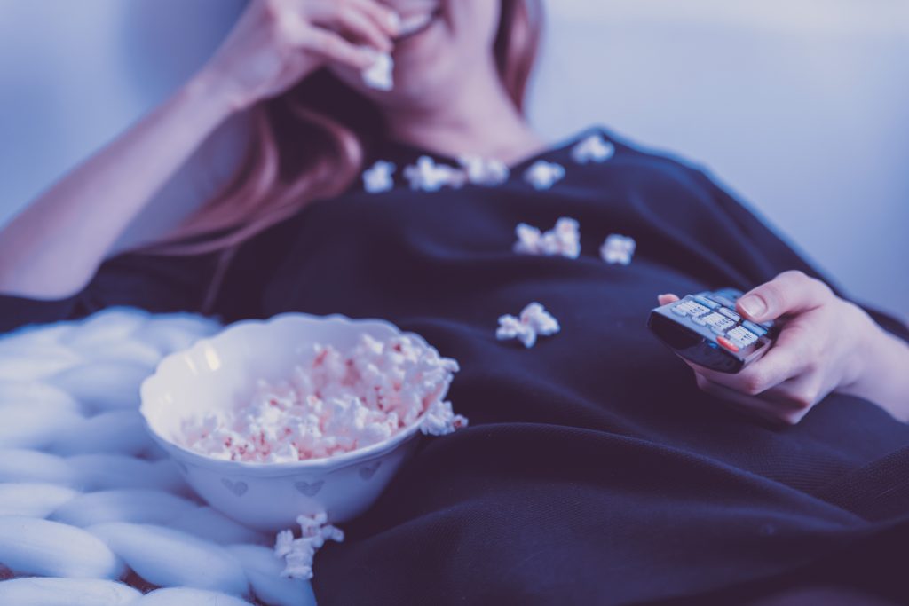 A picture of a woman eating popcorn
