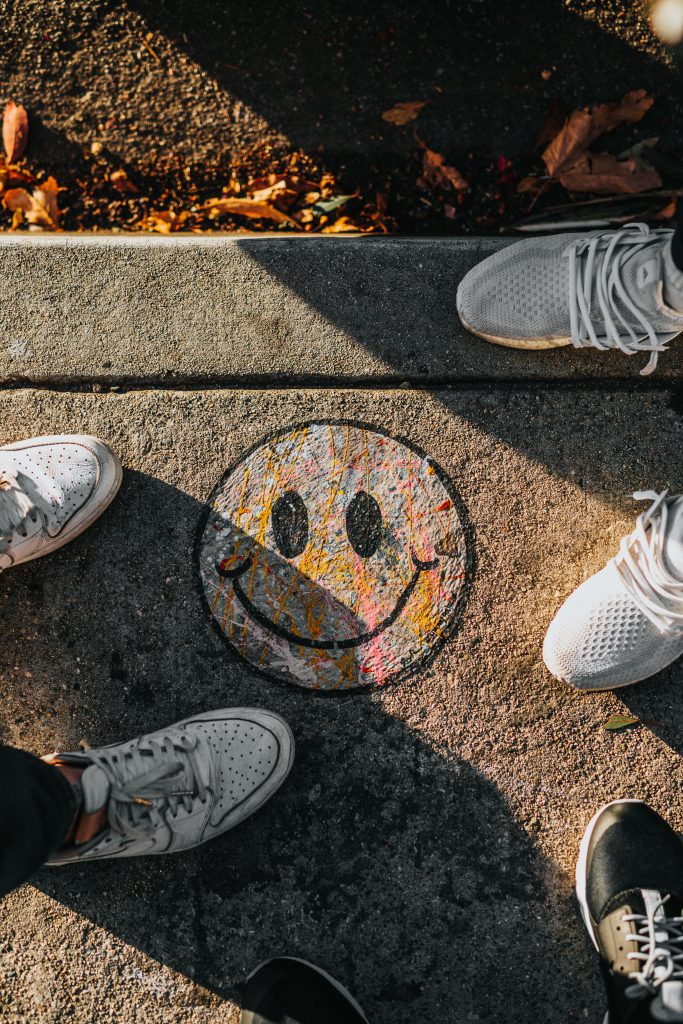 A picture of a smiley face at people's feet