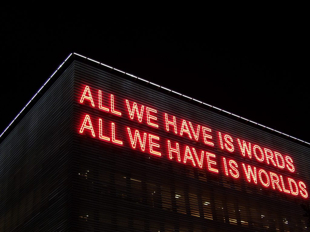 A neon sign about words