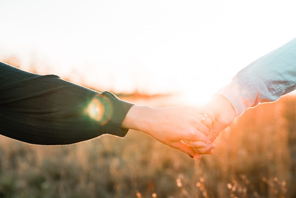 A picture of hands holding in summer