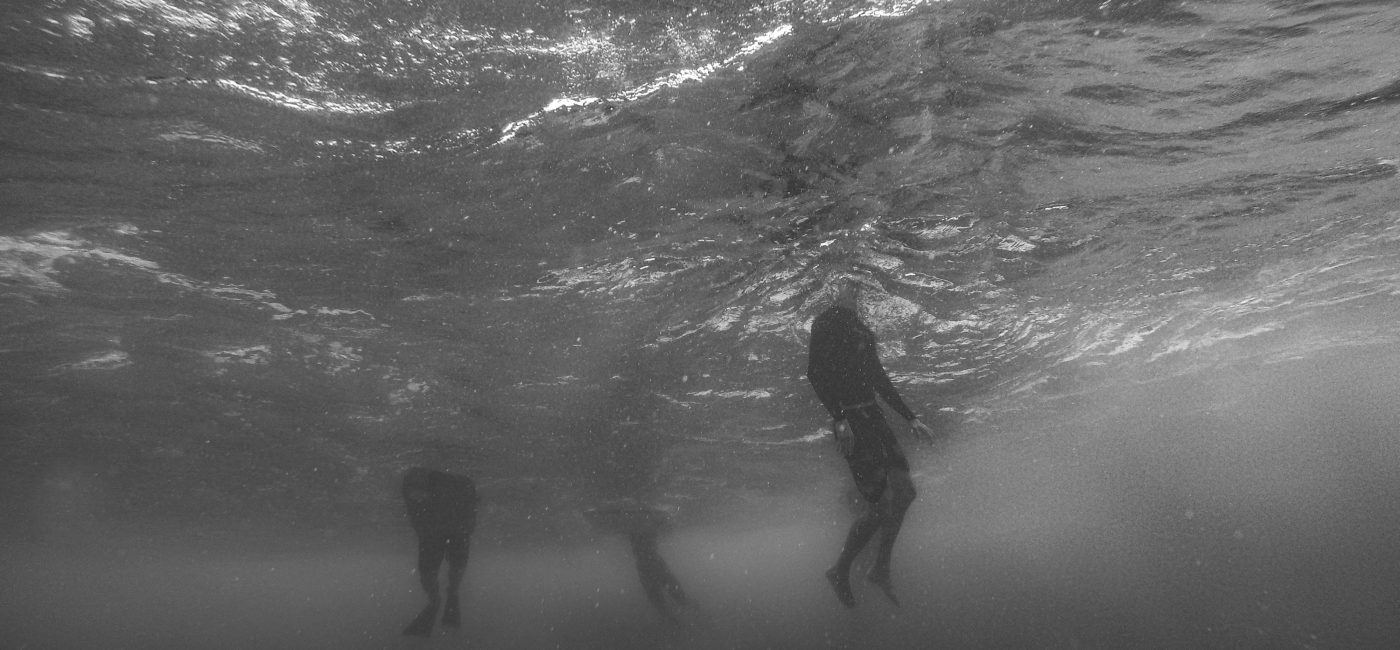 A picture of people with heads just above the water