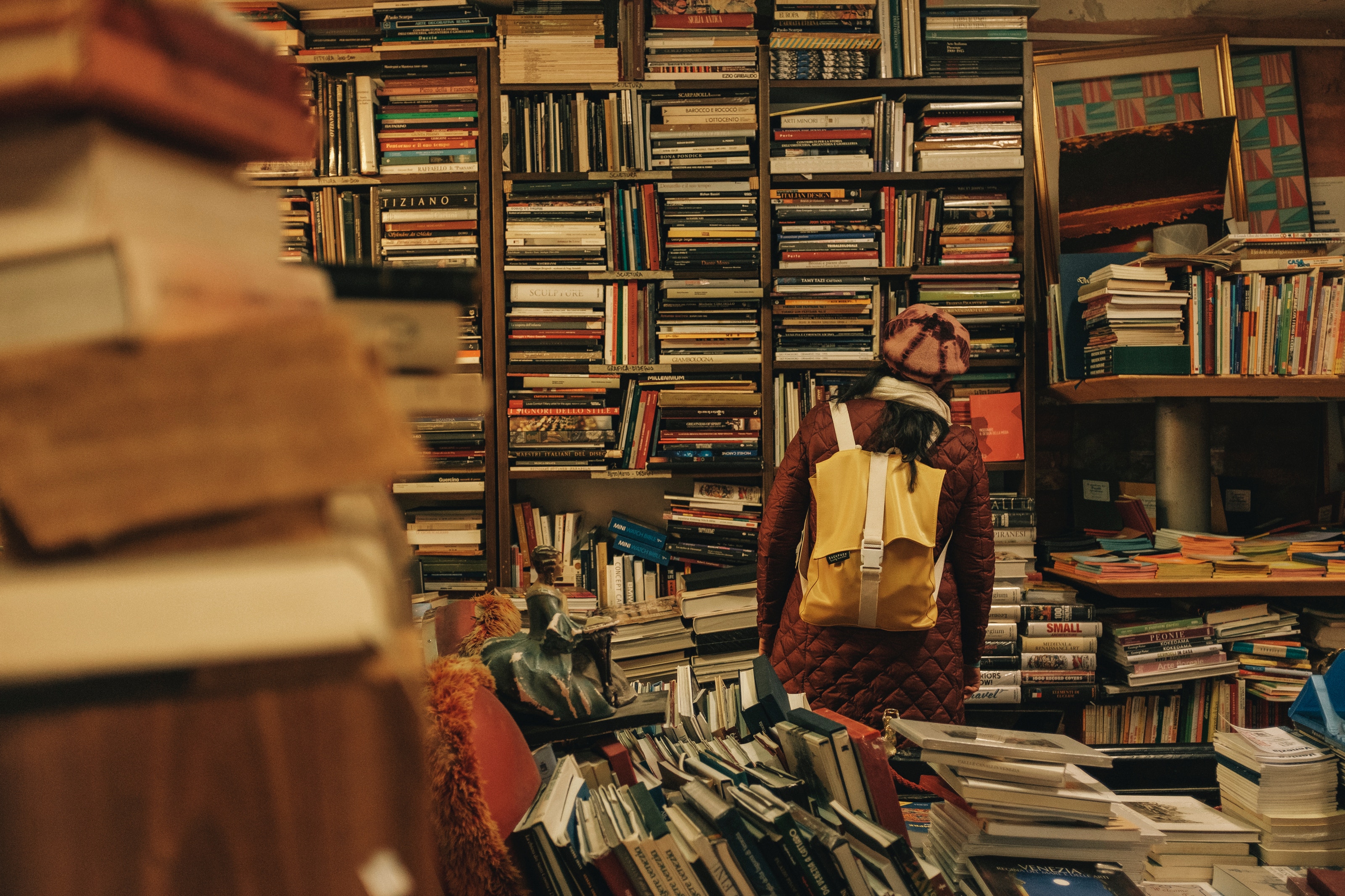 A picture of someone with their face in a bookshelf